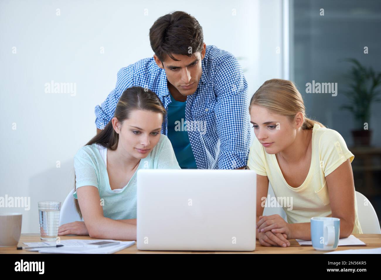 Brainstorming. three colleagues working in an office. Stock Photo