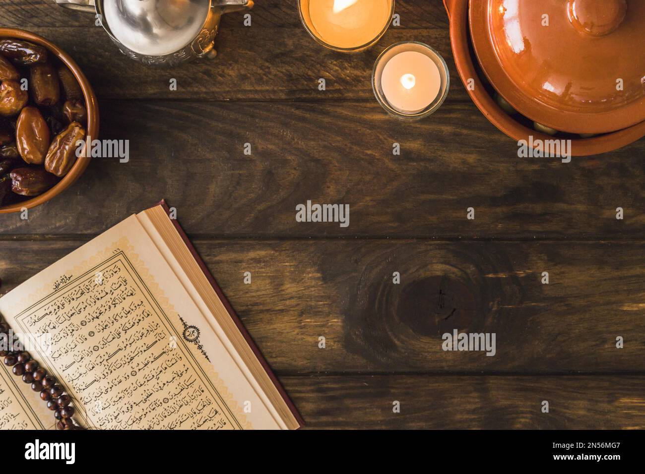 opened quran near dates flaming candles . Resolution and high quality beautiful photo Stock Photo