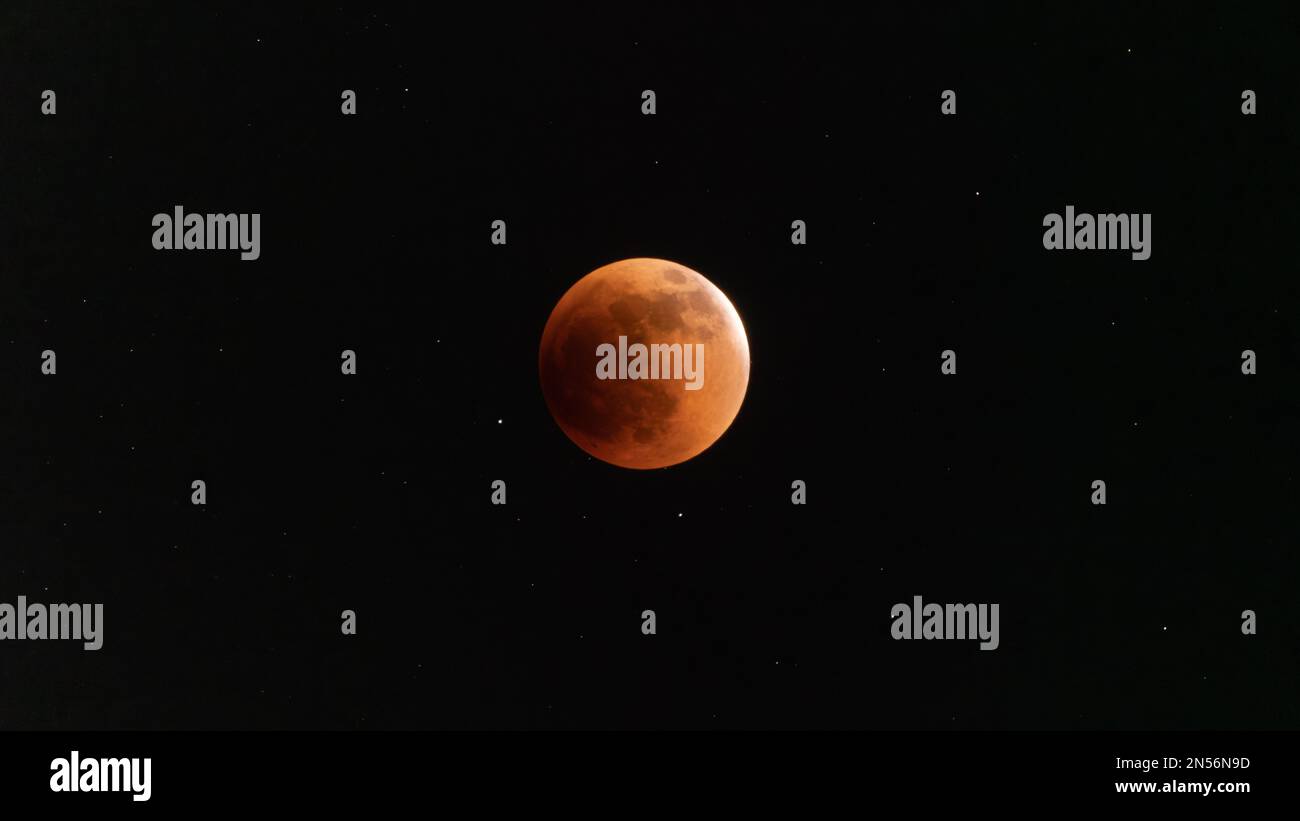 A scenic shot of the total eclipse of the moon in space on a black