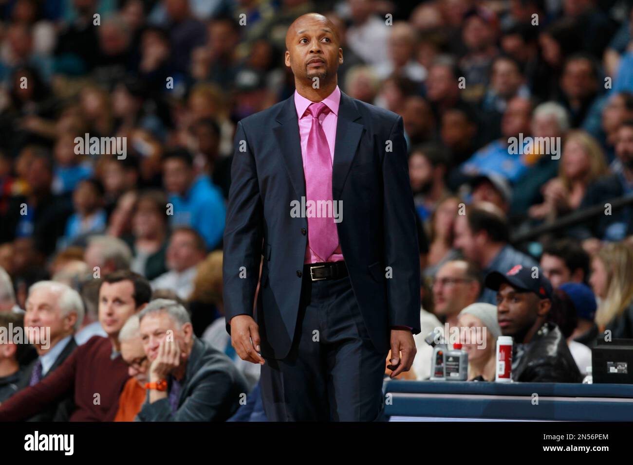 Denver Nuggets head coach Brian Shaw checks scoreboard while facing the