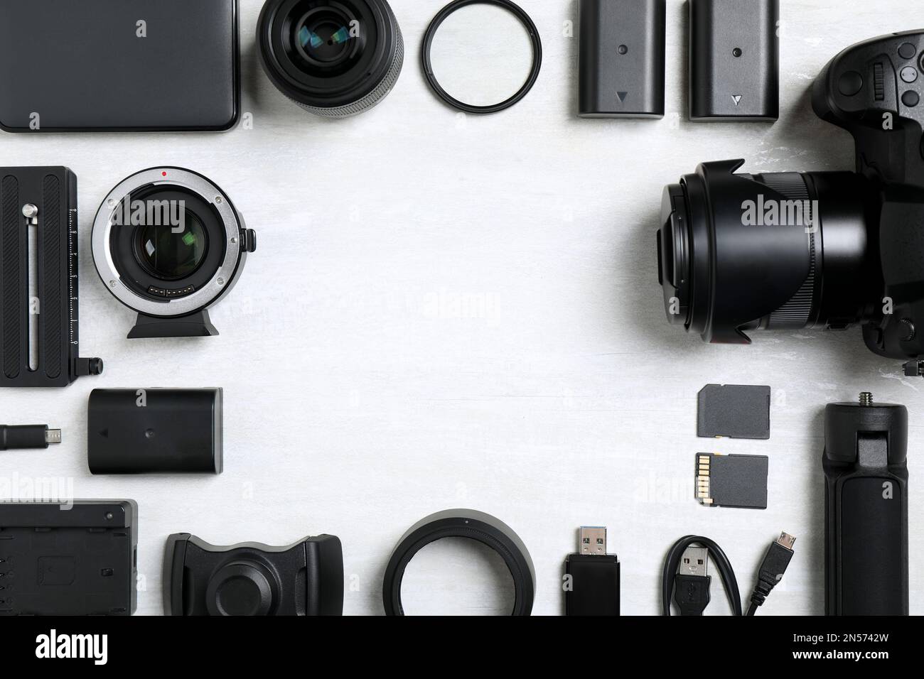 Camera and video production equipment on light background, flat lay ...