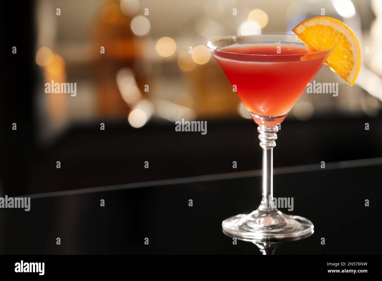 Delicious cocktail with orange on bar counter. Space for text Stock Photo