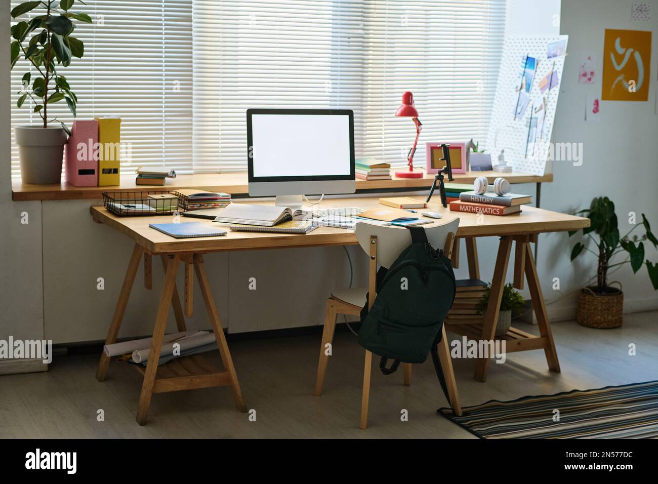 Horizontal image of workplace of schoolchild with computer monitor on it in the room Stock Photo