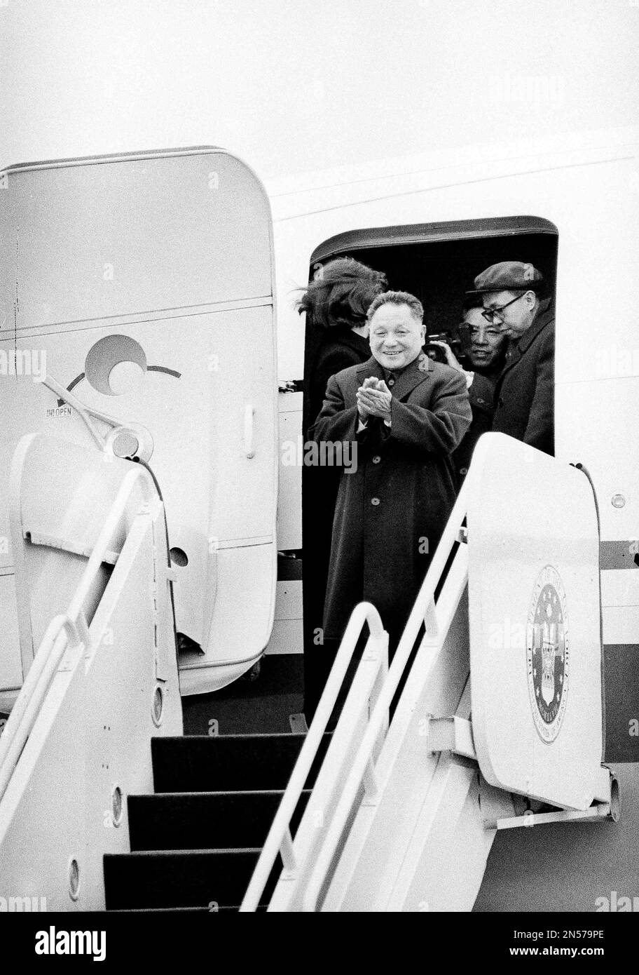 Chinese Vice Premier Teng Hsiaoping applauds from the top of his plane