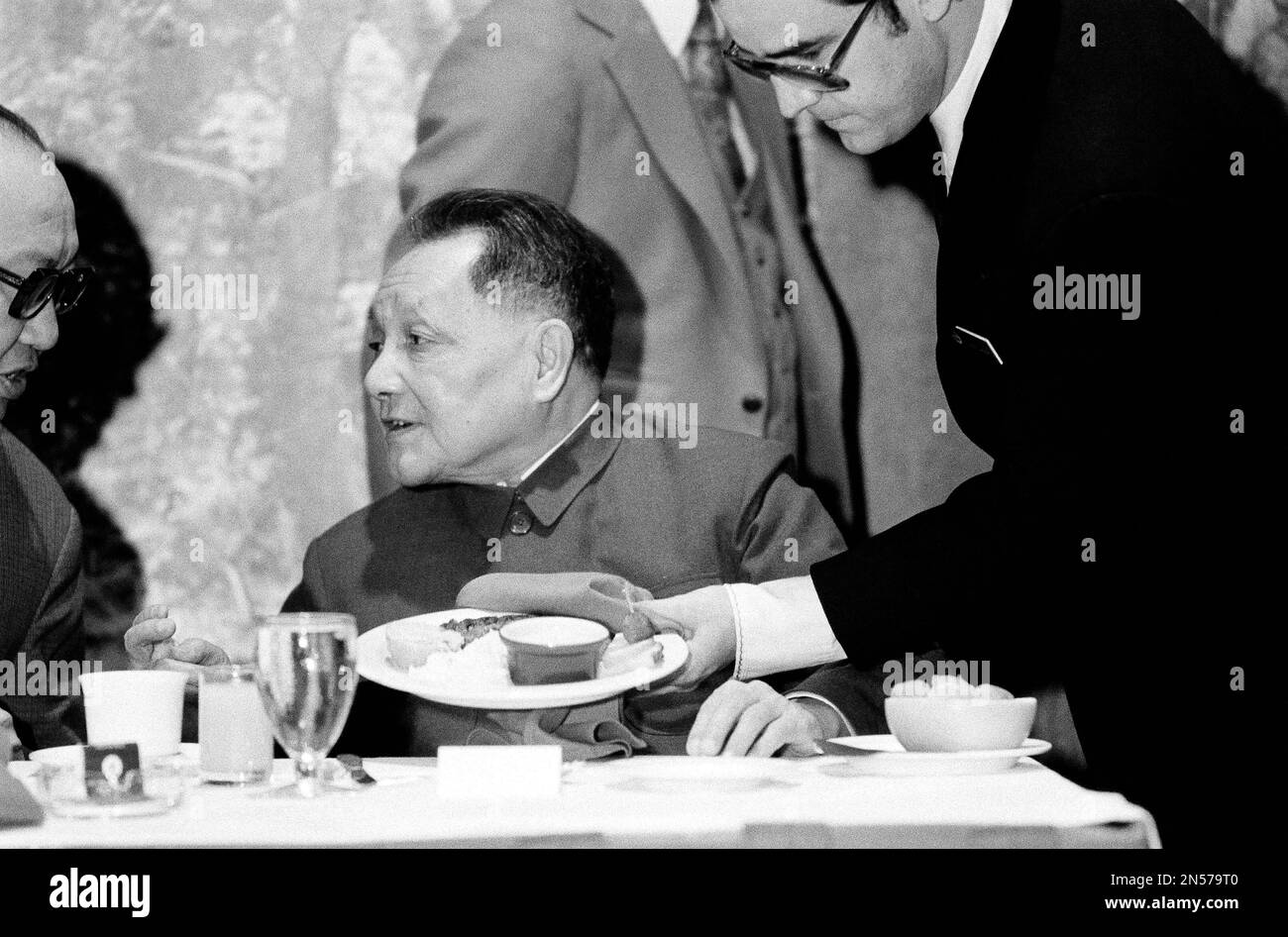 A waiter places a plate for Chinese Vice Premier Teng Hsiao-ping at a ...