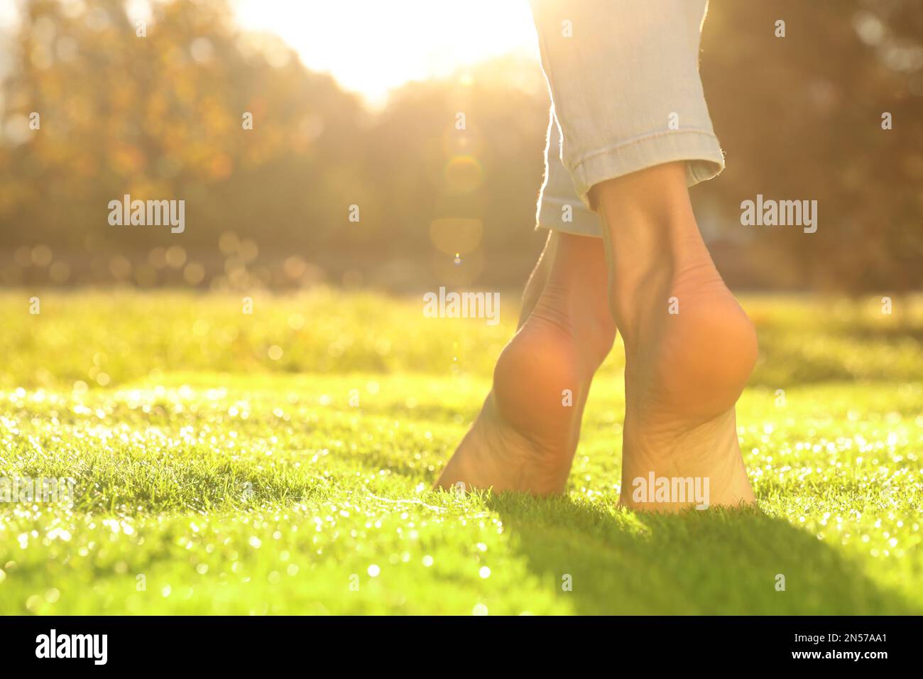 Woman walking barefoot on grass hi-res stock photography and images - Alamy