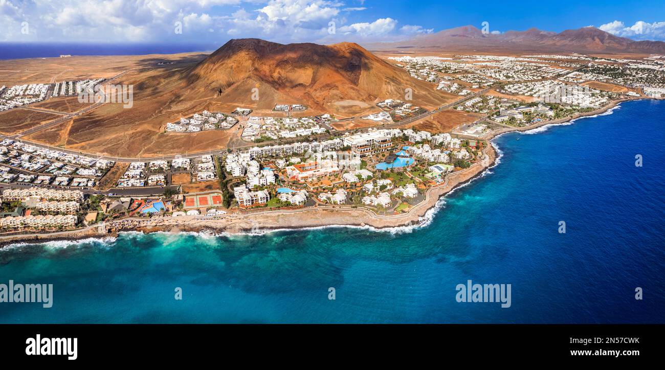 Lanzarote island, Playa Blanca resort. aerial drone panoramic view with Red volcano. Flamingo becah  Canary islands of Spain Stock Photo