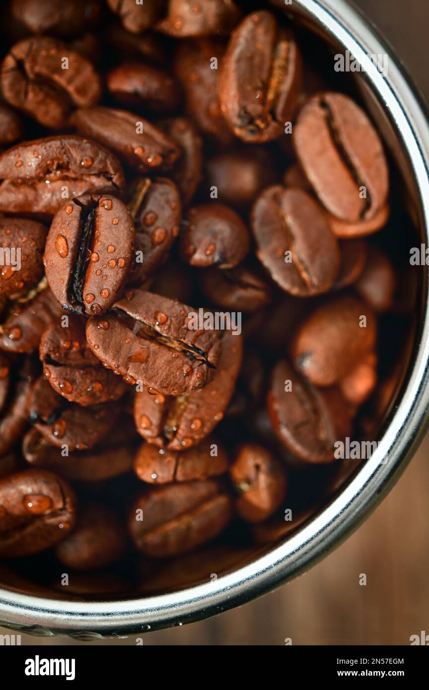 Closeup Roasted coffee beans in Coffee Machine Filter Stock Photo