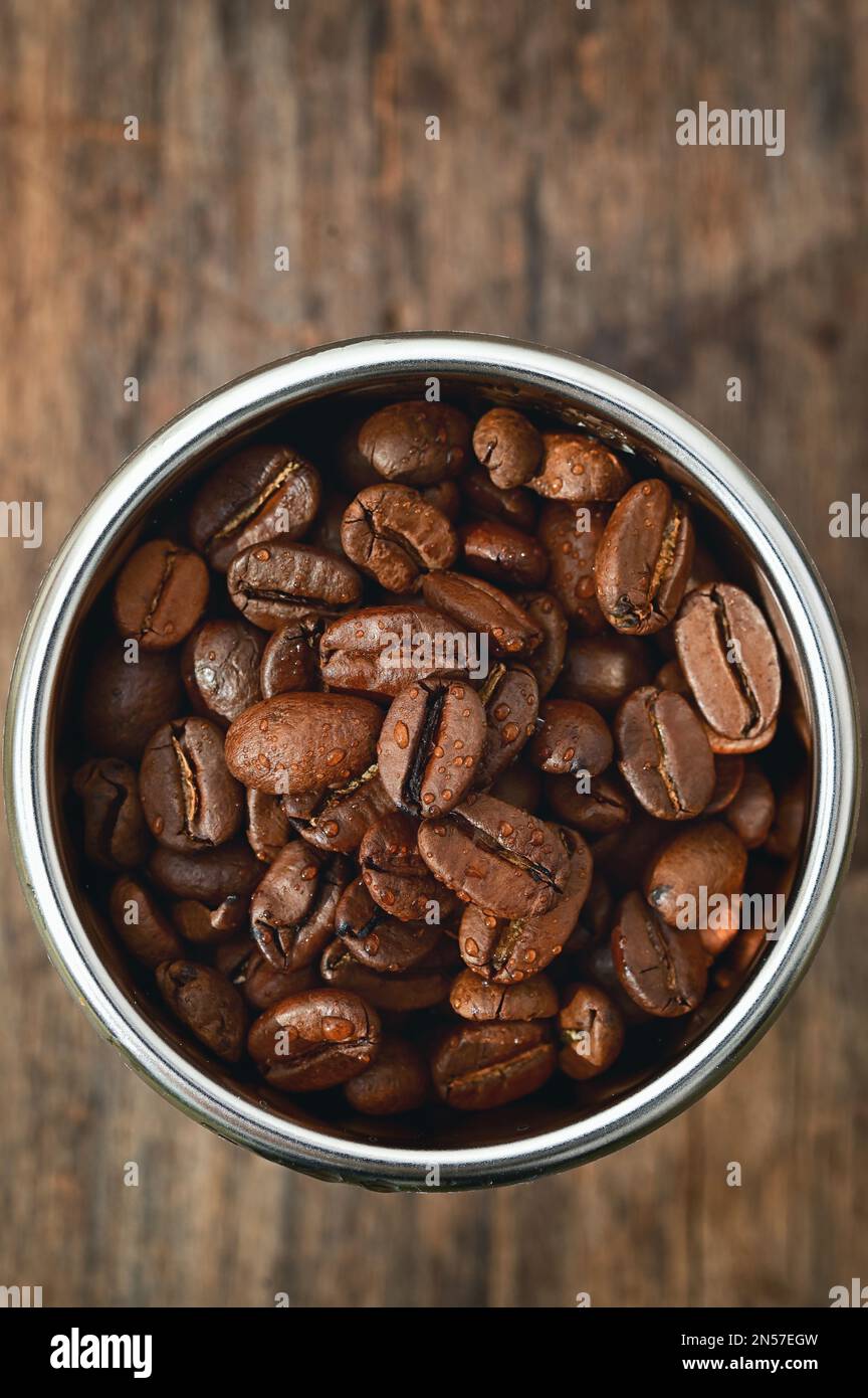 Closeup Roasted coffee beans in Coffee Machine Filter Stock Photo