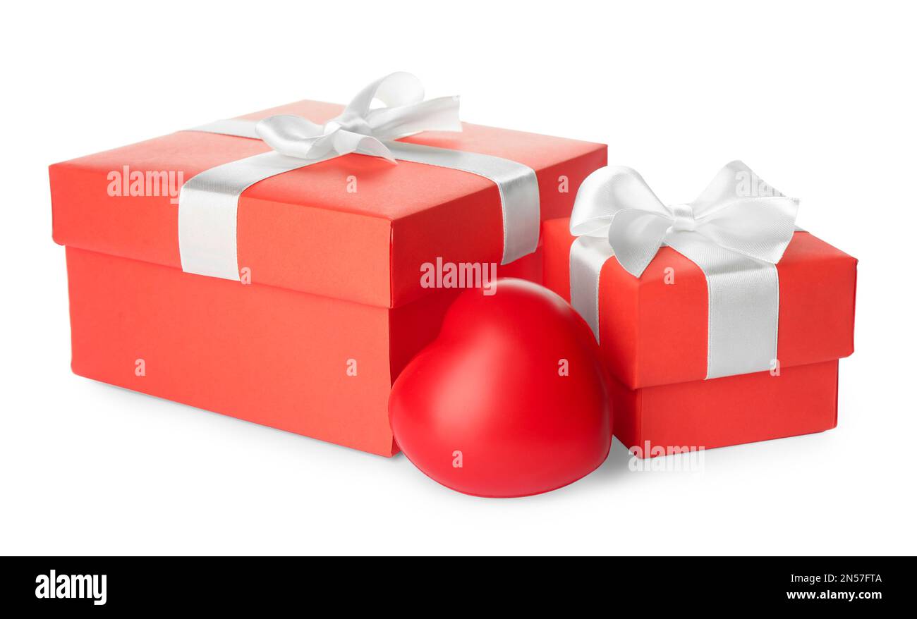 Beautiful gift boxes and red heart on white background. Valentine's day celebration Stock Photo