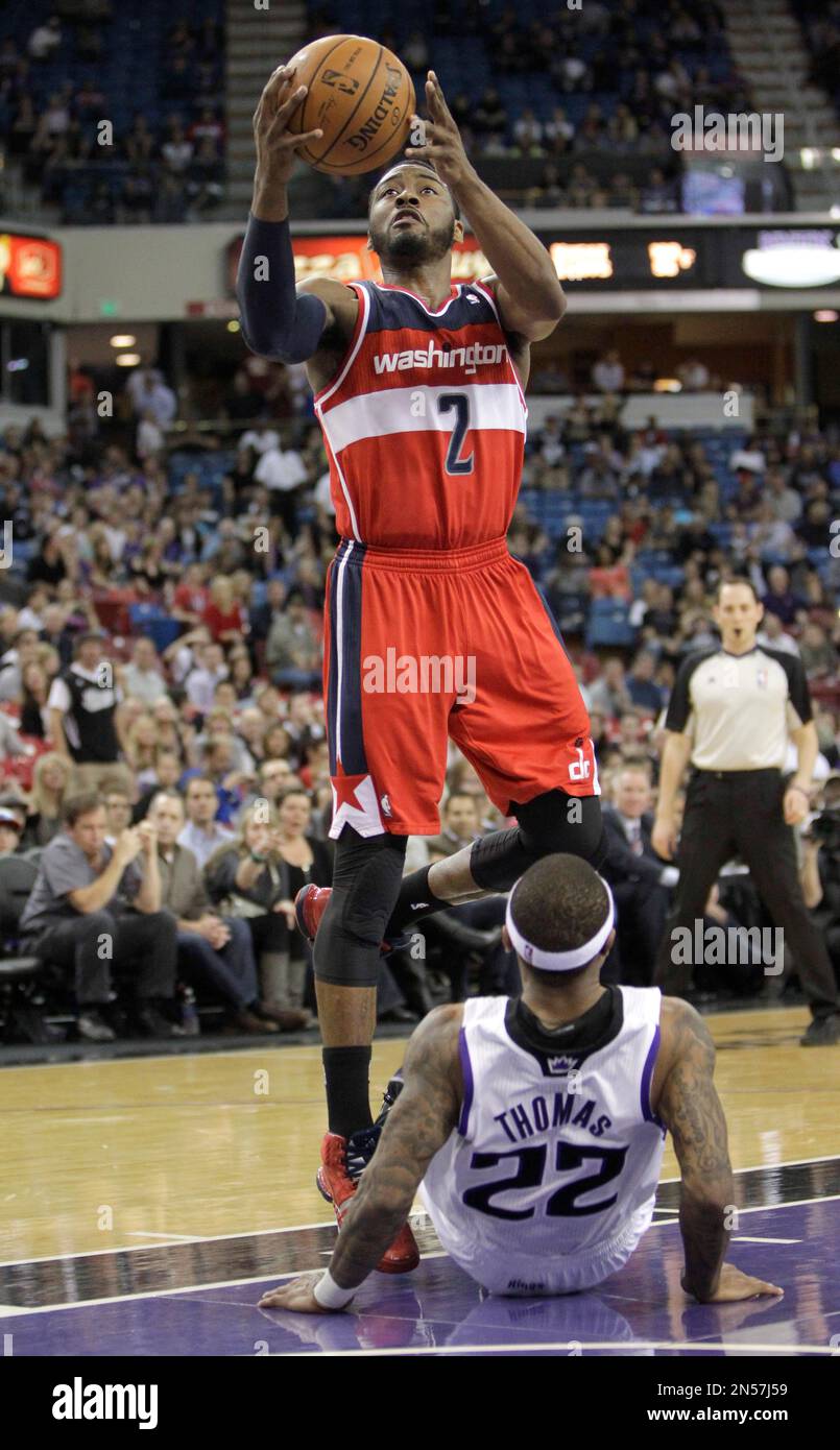 Sacramento Kings guard Isaiah Thomas, right, draws a charging foul