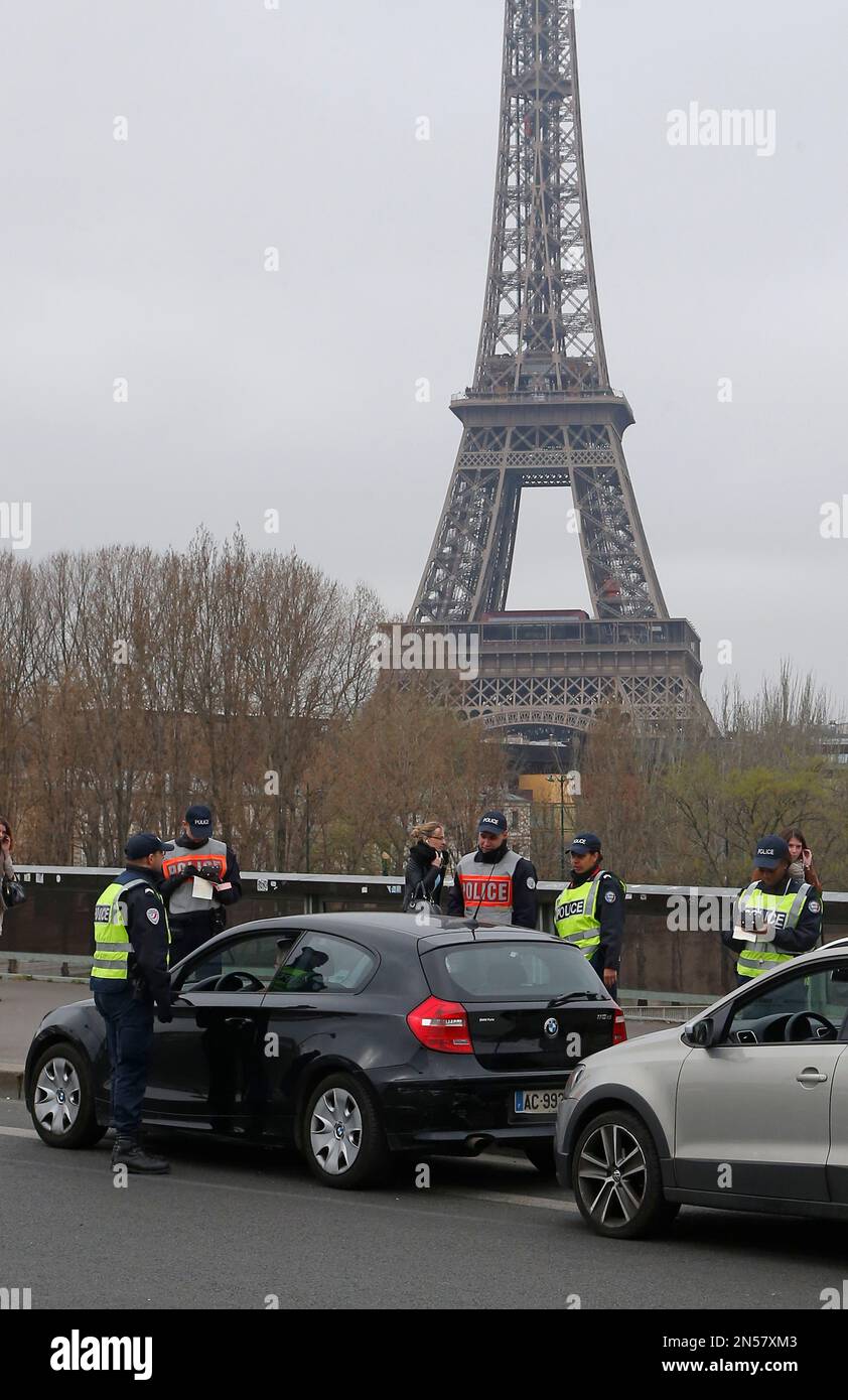 Police officers control vehicles along the Seine river in Paris, Monday