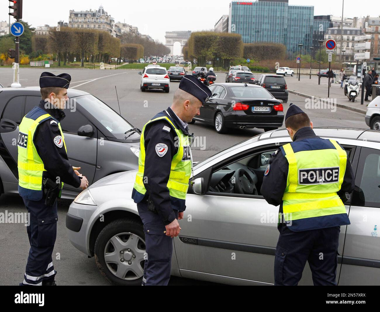 Police officers control a vehicle in Paris, Monday, March 17, 2014