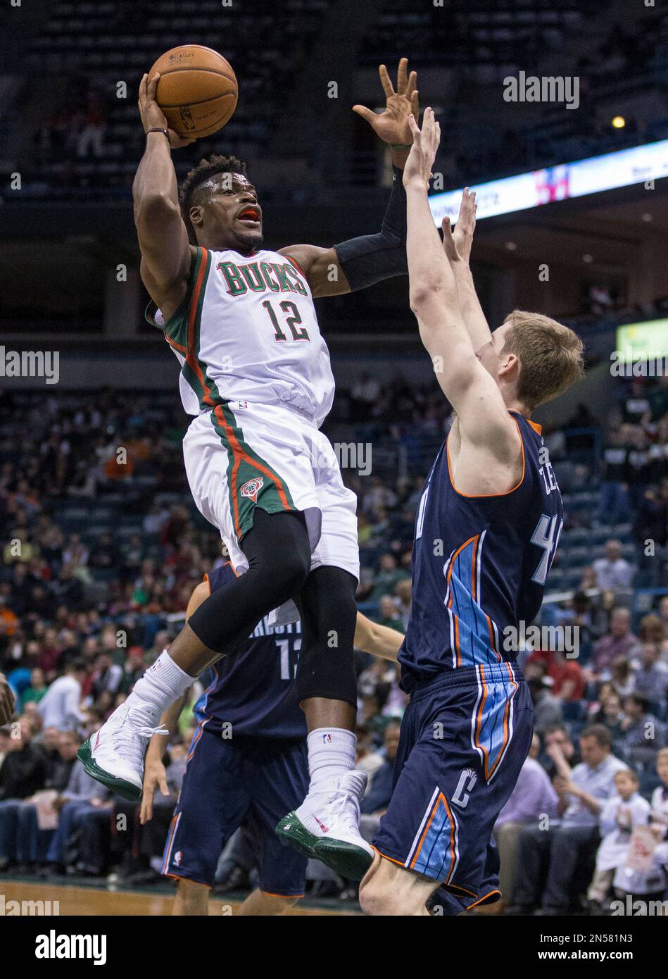 Milwaukee Bucks' Jeff Adrien shoots over Charlotte Bobcats' Cody Zeller
