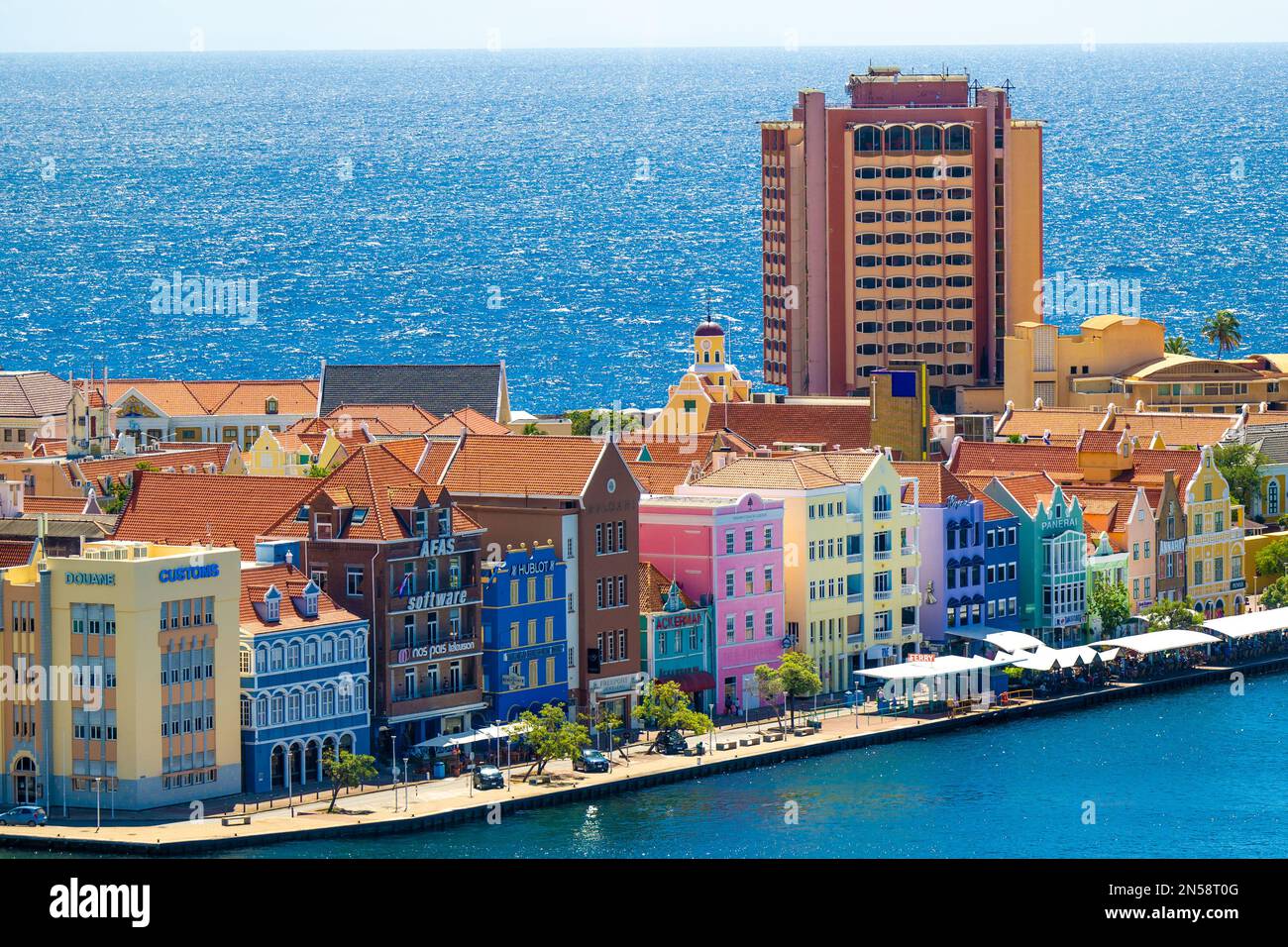 Plaza Hotel that has been empty for years, colorful houses, in Curacao next  to the Koningin Emmabrug: Pontjesbrug (Queen Emma Bridge: The Swinging Old  Lady of Curacao, the only floating bridge in