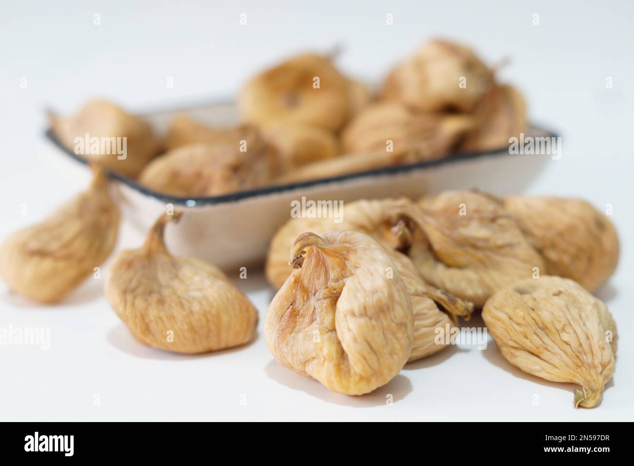 Dried figs in plate isolated on white Stock Photo