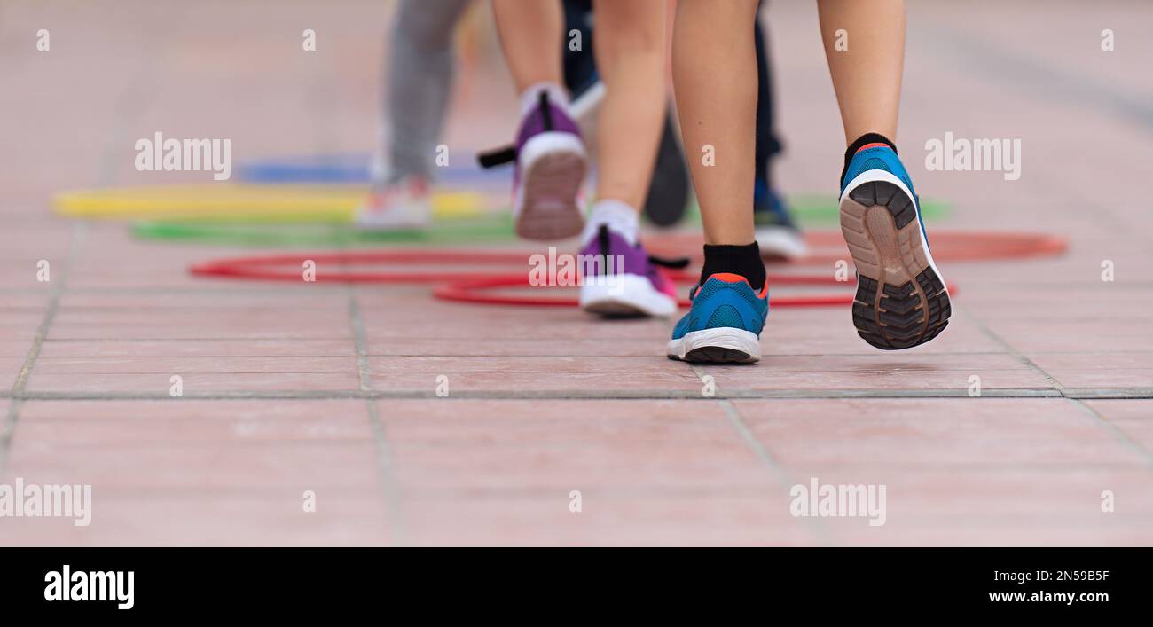 Competitive active game, children jump over obstacles Stock Photo - Alamy