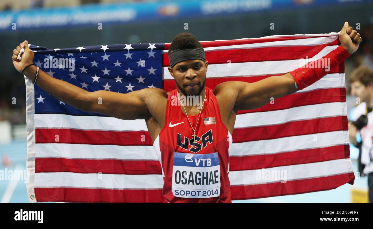 United States' Omo Osaghae carries the national flag after winning the