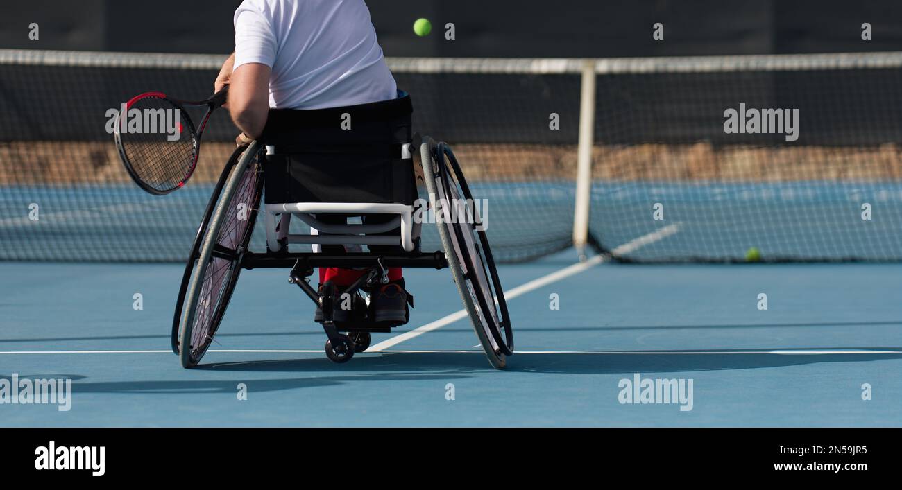 Men on wheelchair playing tennis on tennis court Stock Photo Alamy