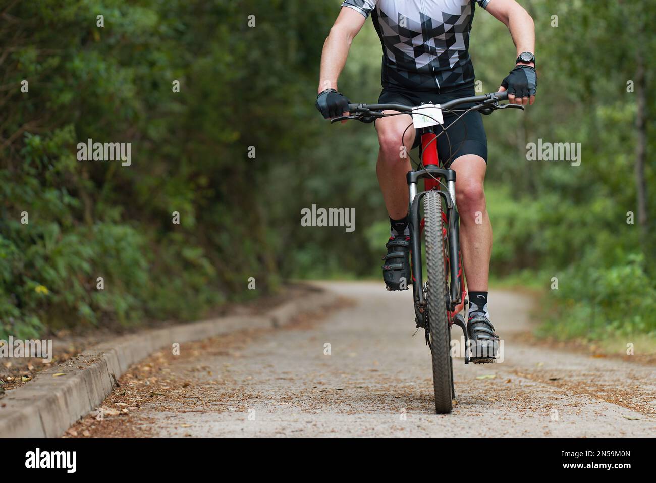 Mountain biker riding on bike singletrack trail, mountain bike race