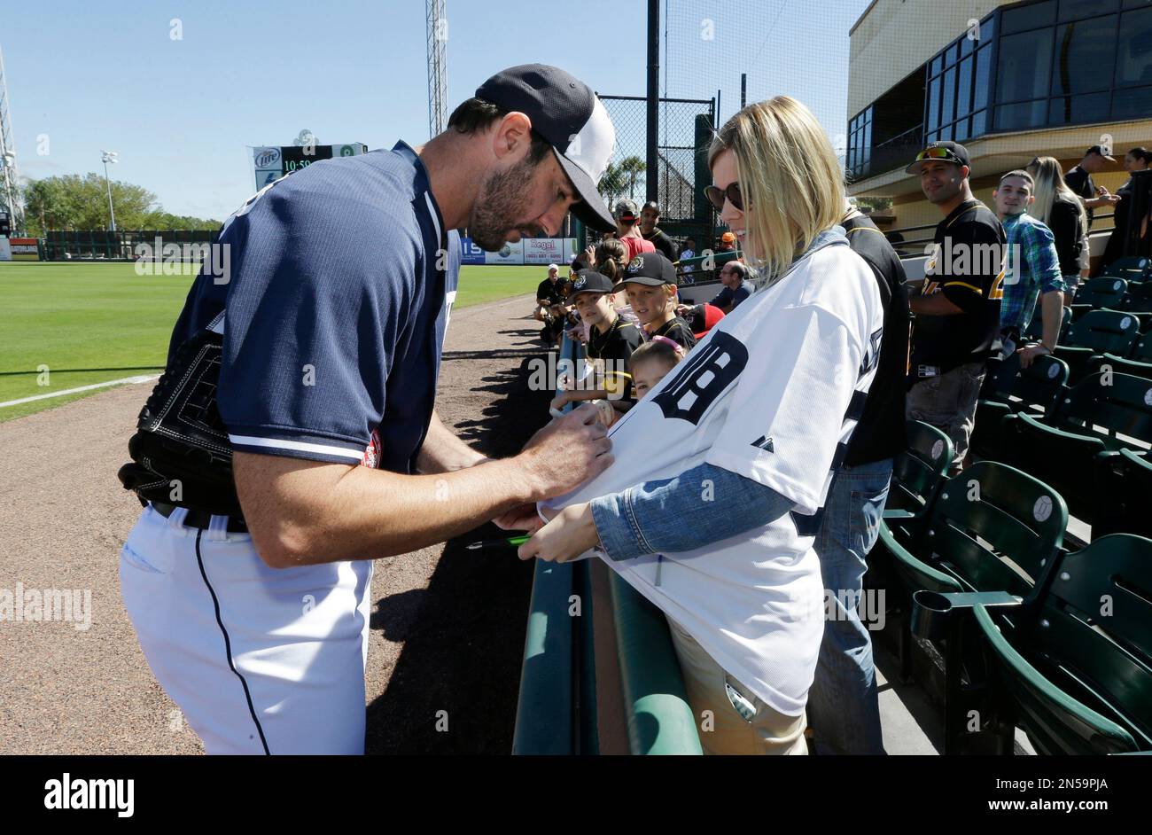 Detroit Tigers pitcher Justin Verlander signs the jersey of B