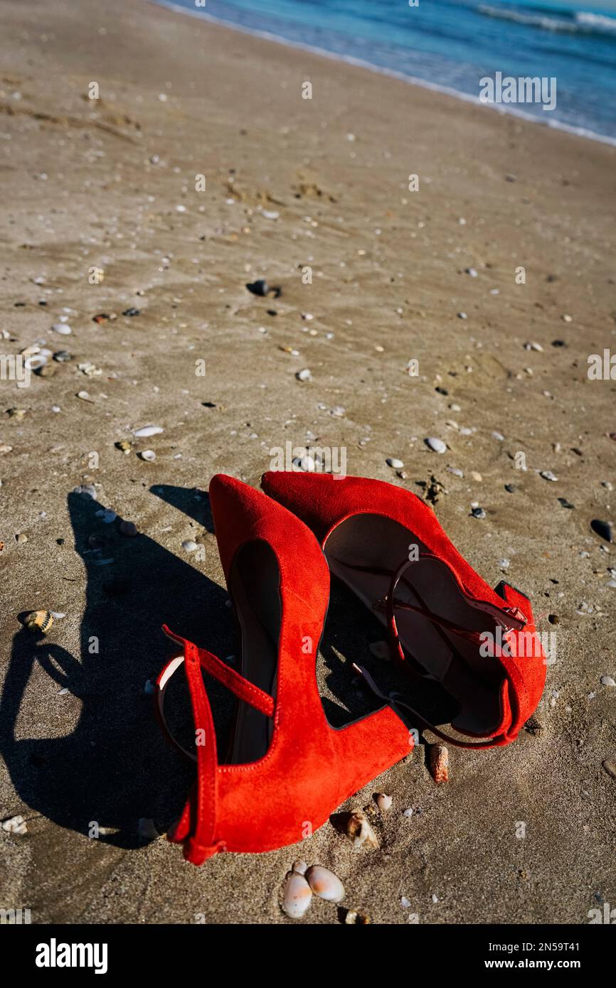 Red high heels with retro style abandoned in a seashore near the sea Stock  Photo - Alamy
