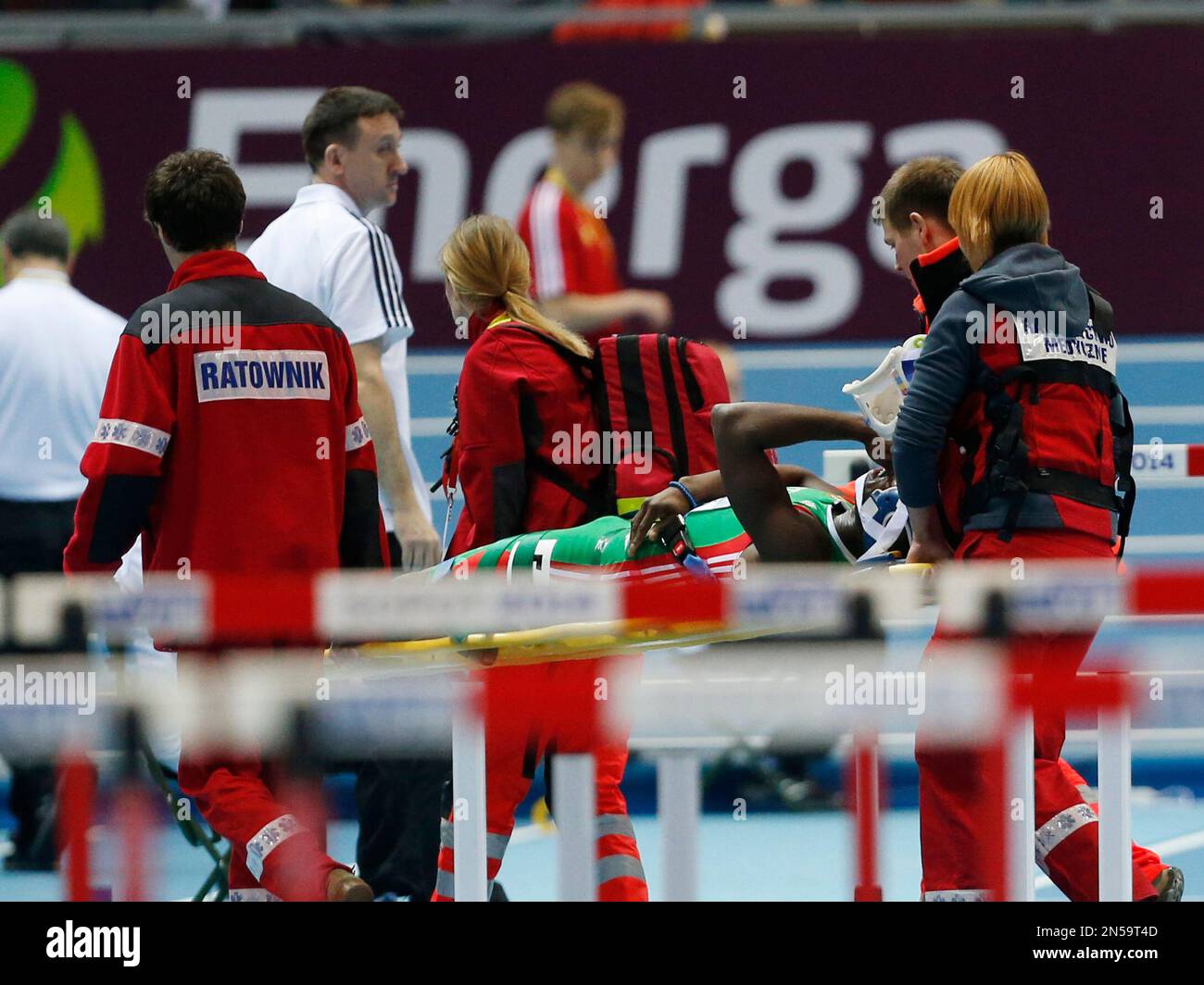 Portugal's Rasul Dabo is carried away after he fell in his 60m hurdles heat during the Athletics World Indoor Championships in Sopot, Poland, Saturday, March 8, 2014. (AP Photo/Petr David Josek) Stock Photo