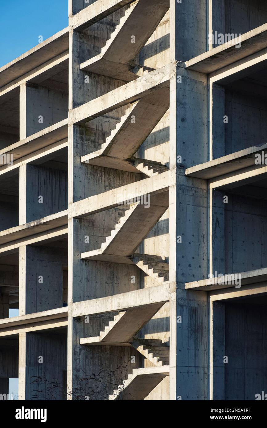 Reinforced concrete stairs in building construction site. House construction. Abstract minimal geometric architecture background. Vertical orientation Stock Photo