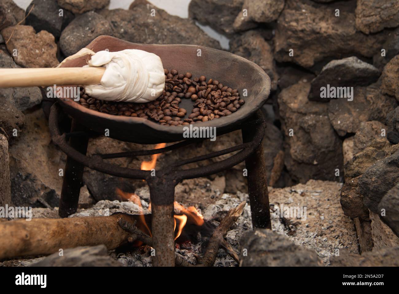 Roasting coffee beans in a clay wok over a wood fire Stock Photo Alamy