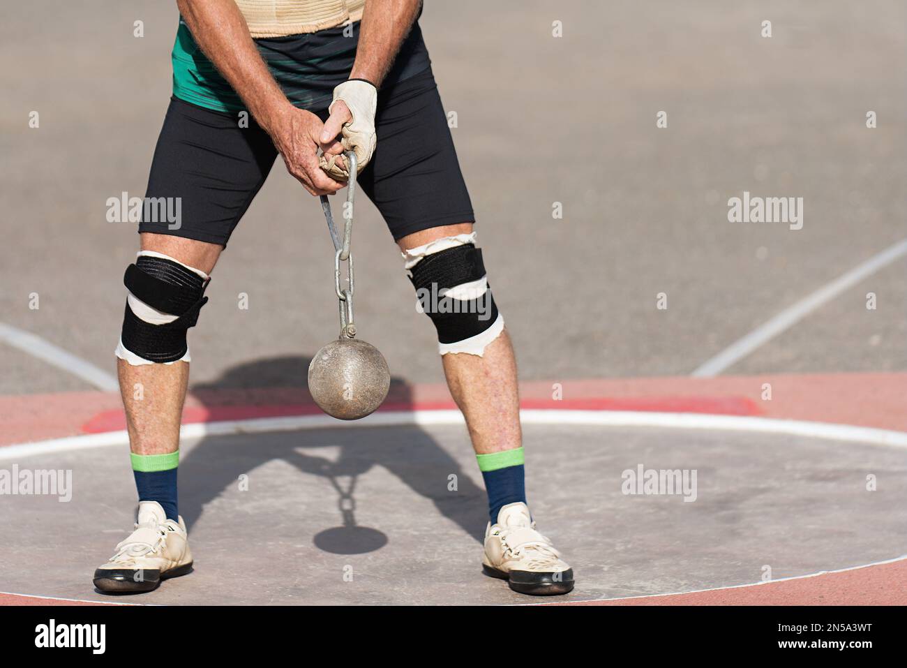 An athlete competing in the hammer throw event, athlete performing a