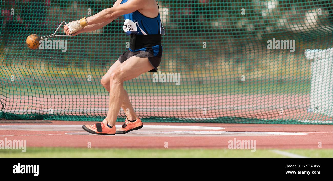 An athlete competing in the hammer throw event, athlete performing a