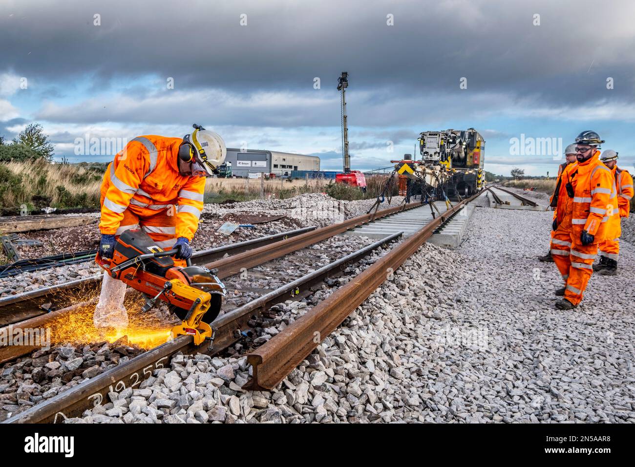 Railway workers building new railway and knocking down bridges Stock Photo