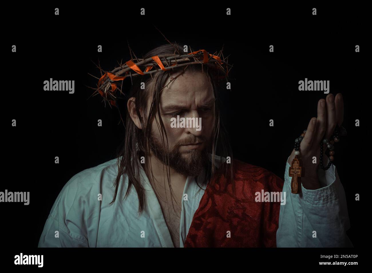 Jesus Christ wearing a crown of thorns and white chiton toga mantle