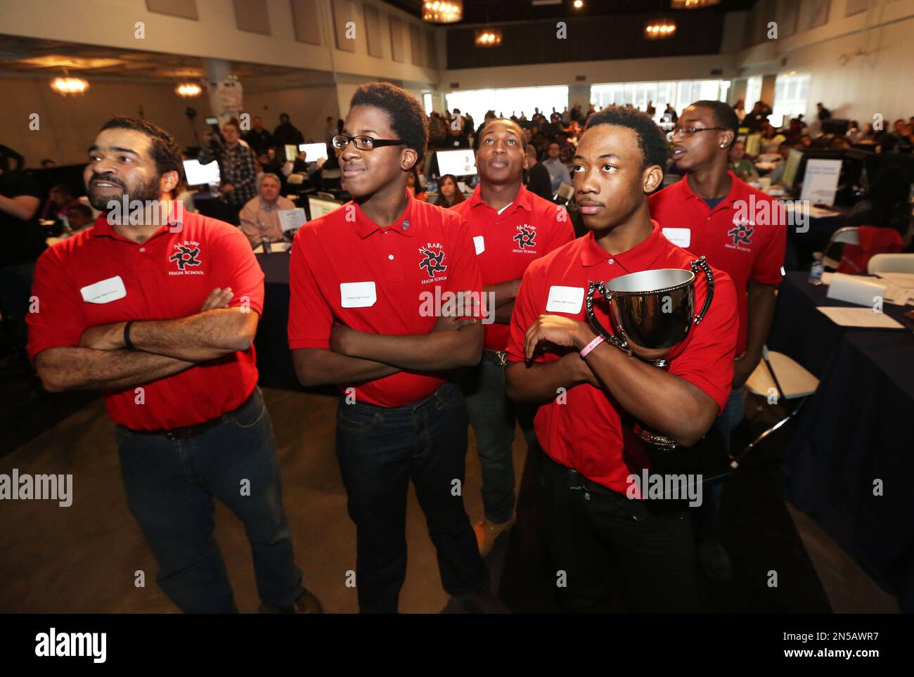 Business and technology teacher John Johnson, left, stands with his  students from Al Raby High School (L-R) Ken Dean, Keshawn Johnson, Anthony  Knighton, and Hakeem Shepphard with their first place trophy after