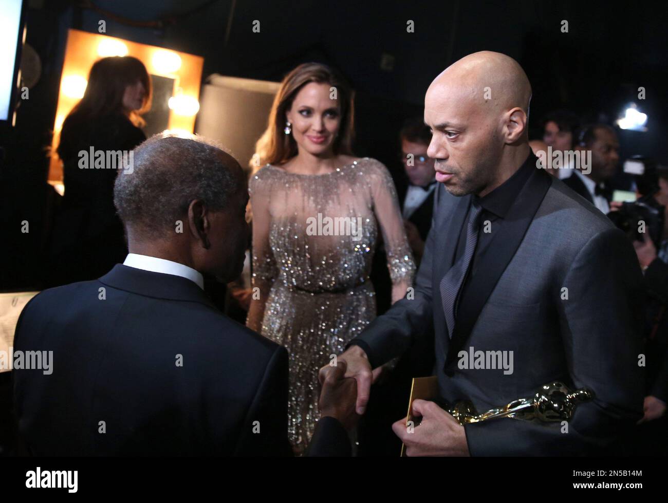 Sidney Poitier, left, speaks with John Ridley , right, as Angelina ...