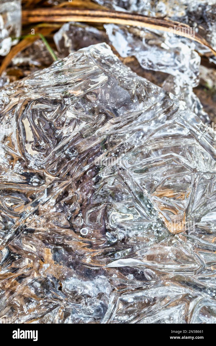 Piece of crystal clear ice in nature. Close-up. Background, texture, pattern. Template for an inscription. Icy spring nature Stock Photo
