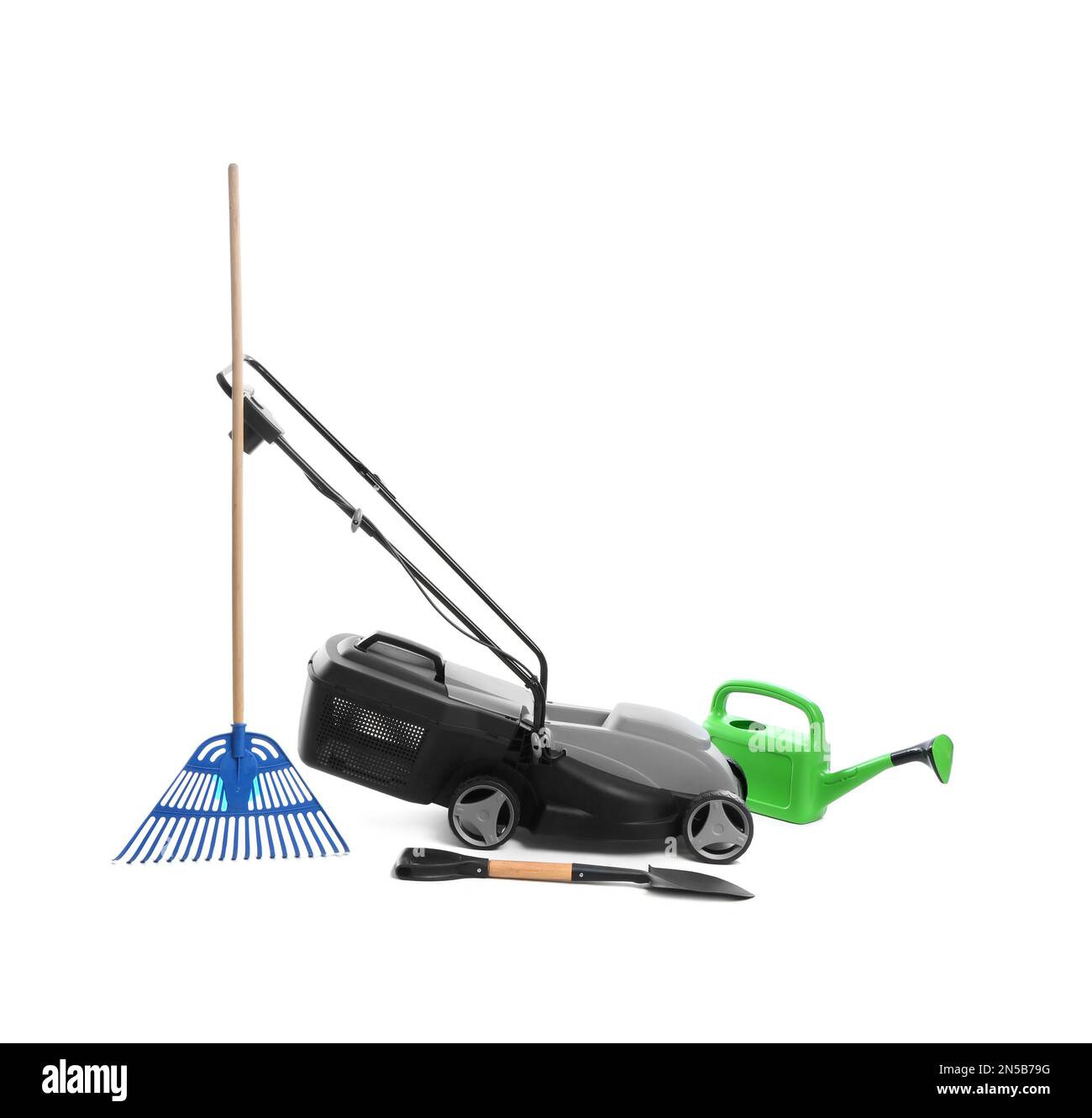 Modern electric grass cutter and gardening tools on white background