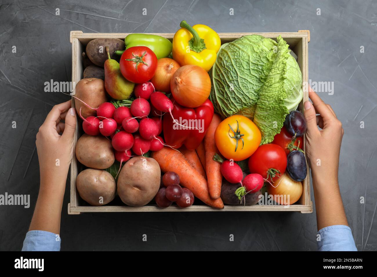 Farmer with wooden crate full of different vegetables and fruits at ...