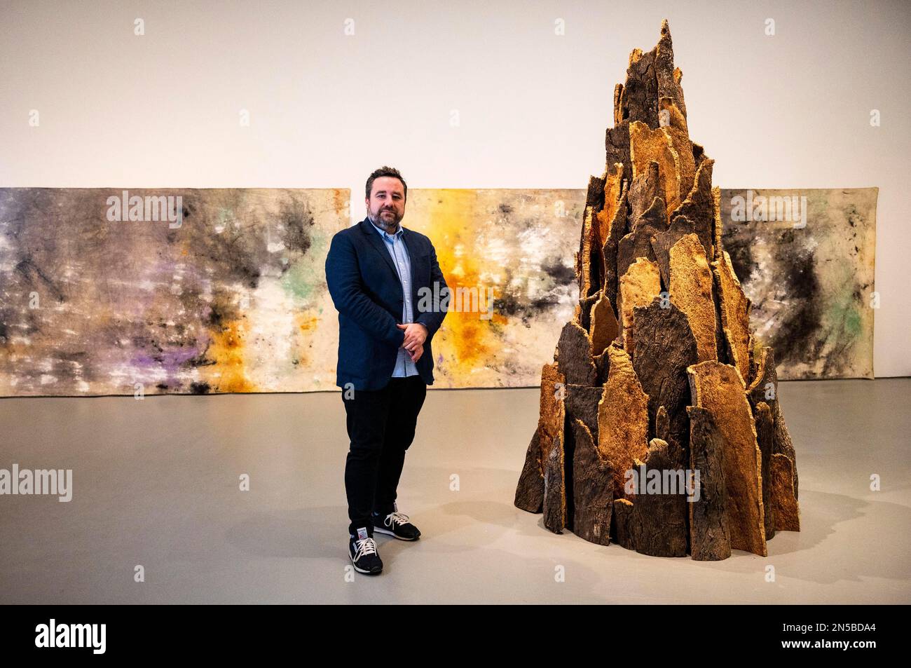 Brighton UK 9th February 2023 - Joe Hill the director and CEO of Towner Eastbourne alongside a David Nash sculpture which is part of the Towner 100 centenary exhibitions . Towner Eastbourne is celebrating its centenary year with a series of major exhibitions from the past and present which opens to the public this coming weekend  : Credit Simon Dack / Alamy Live News Stock Photo