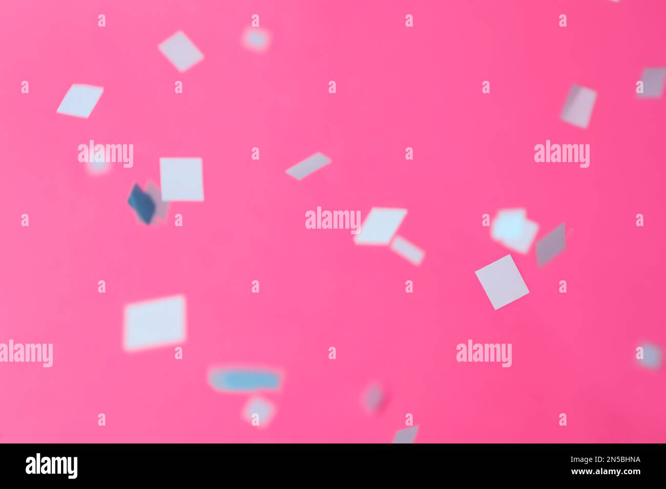 Grey confetti falling down on pink background Stock Photo Alamy