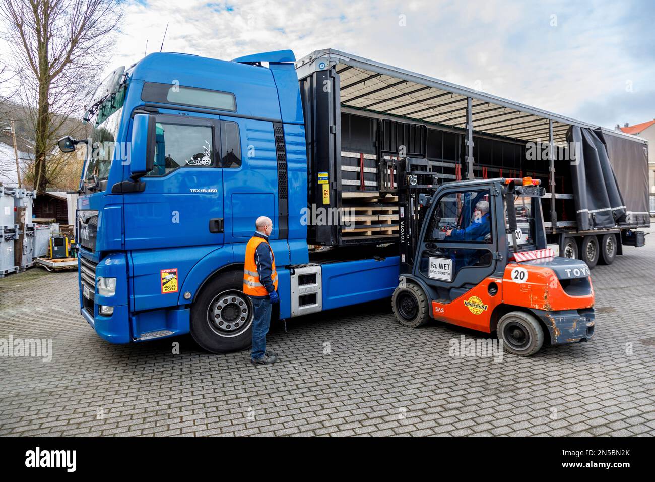 Freight transport, professional drivers in the loading zone, loading