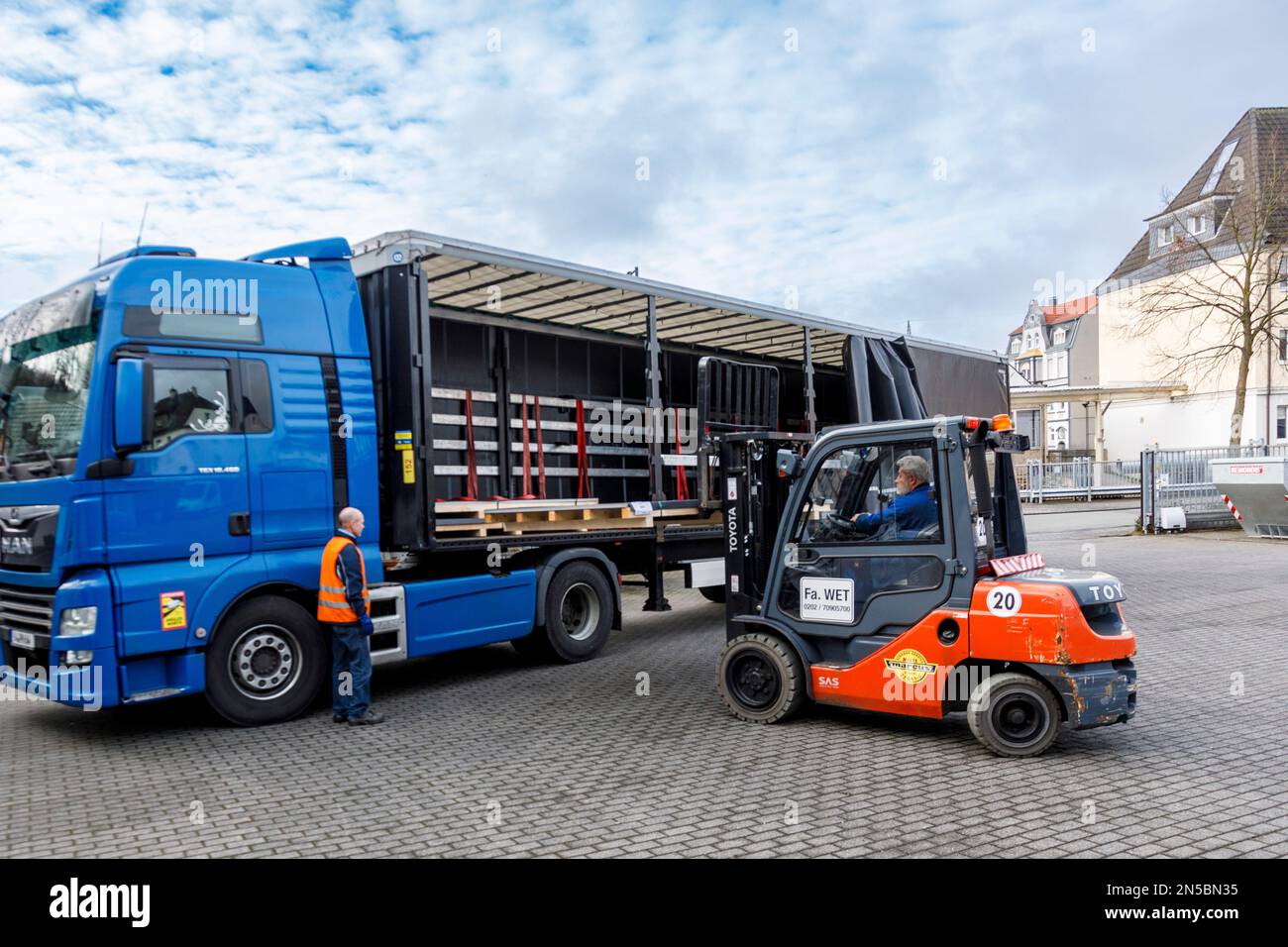 Freight transport, professional drivers in the loading zone, loading
