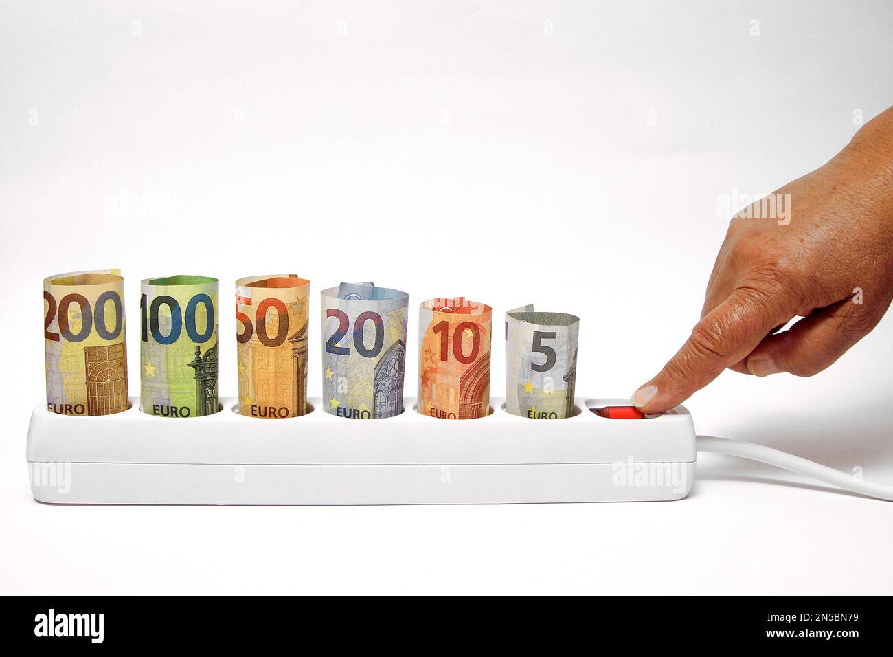 power socket with Euro bills is switched on, price increase of energy Stock Photo