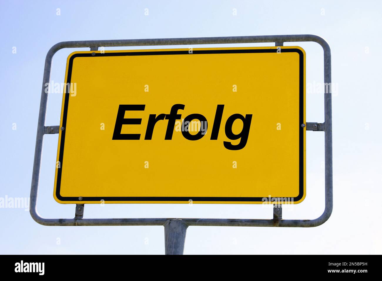 city sign against blue sky lettering Erfolg, success - Composing, Germany Stock Photo