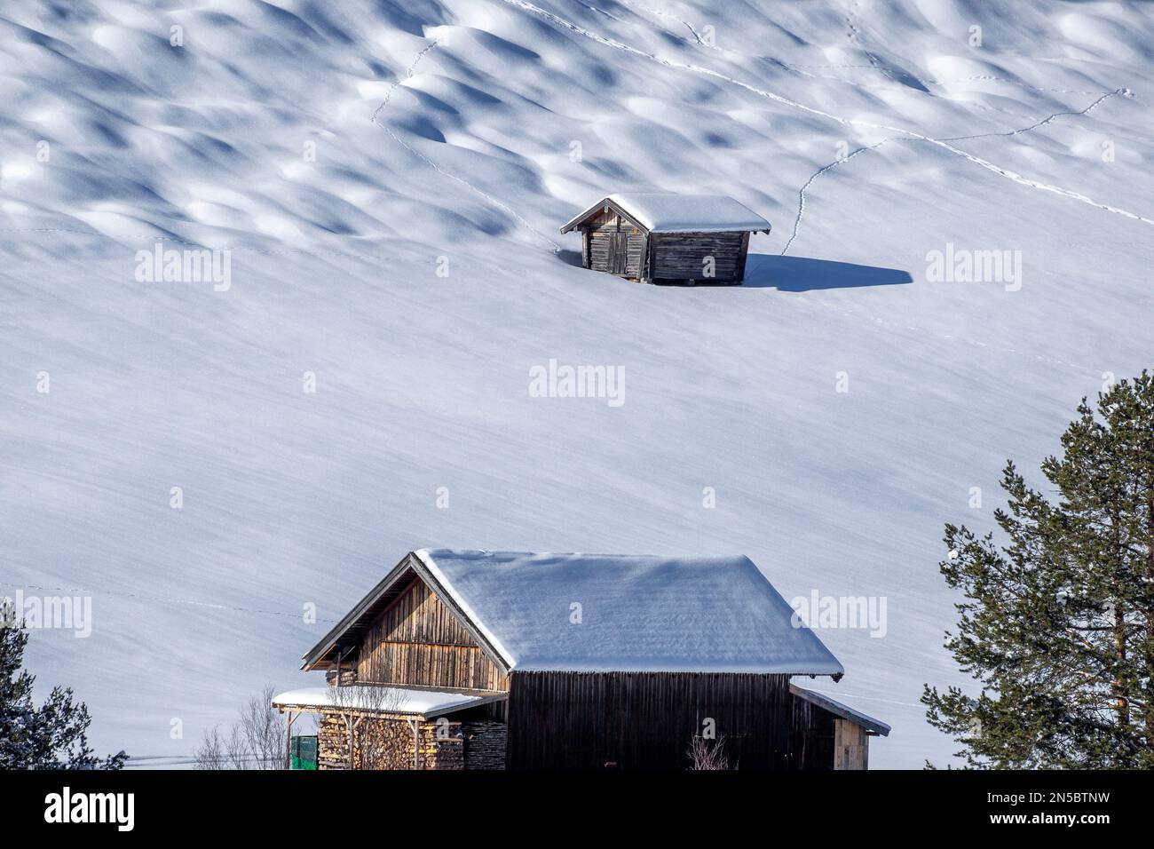 wooden barns and hummock meadows in the snow, Germany, Bavaria, Mittenwald Stock Photo