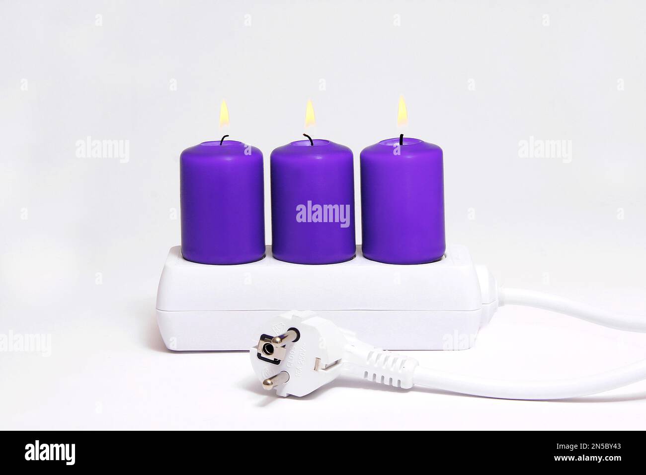 power socket with candles, saving energy Stock Photo Alamy