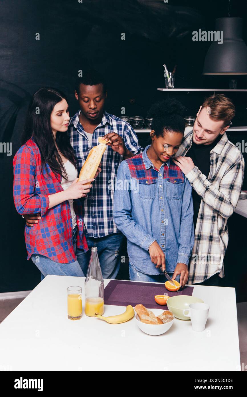 Two young happy couples cook on kitchen together Stock Photo - Alamy