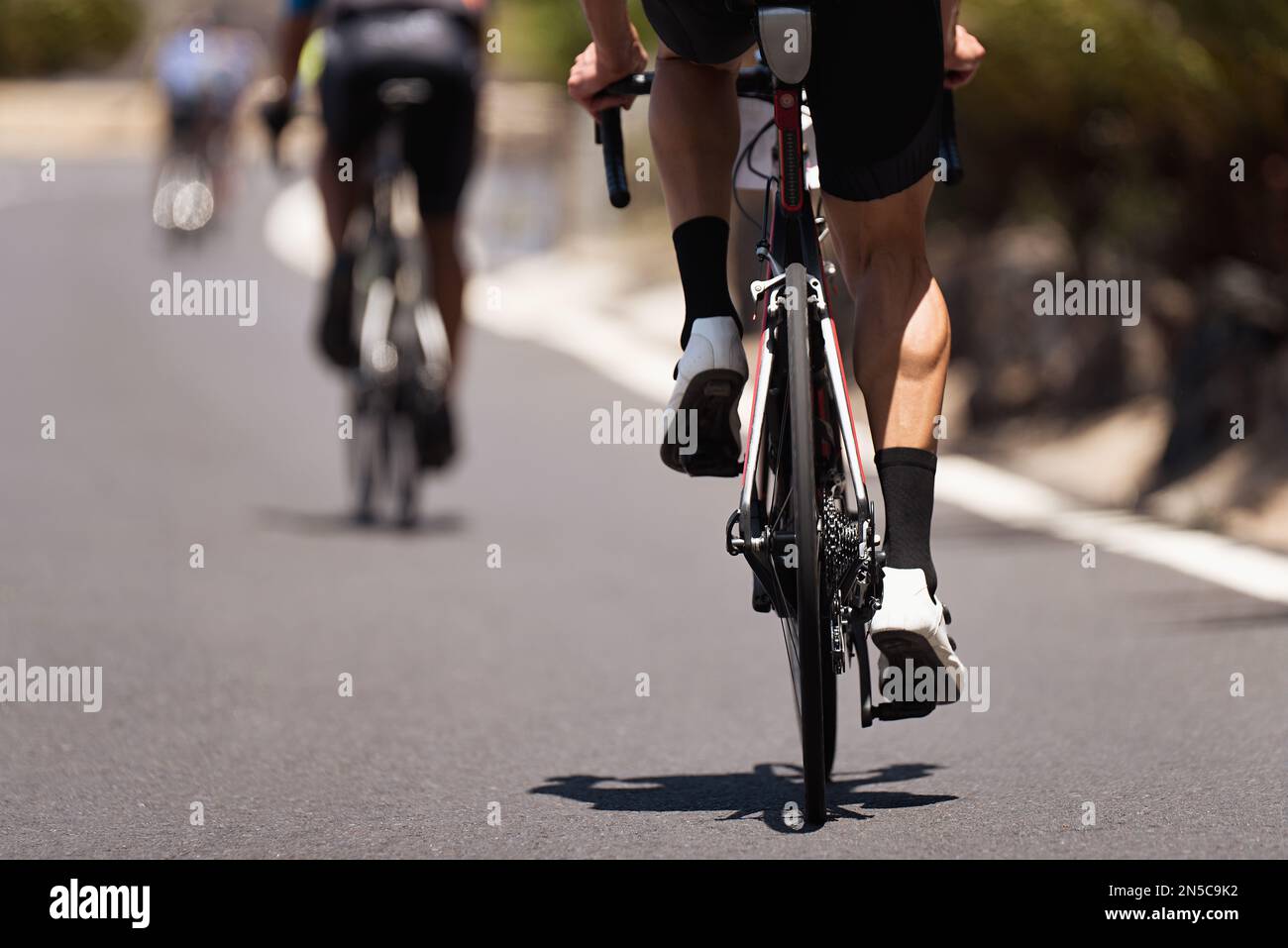 Cycling competition, cyclist athletes riding a race, climbing up a hill