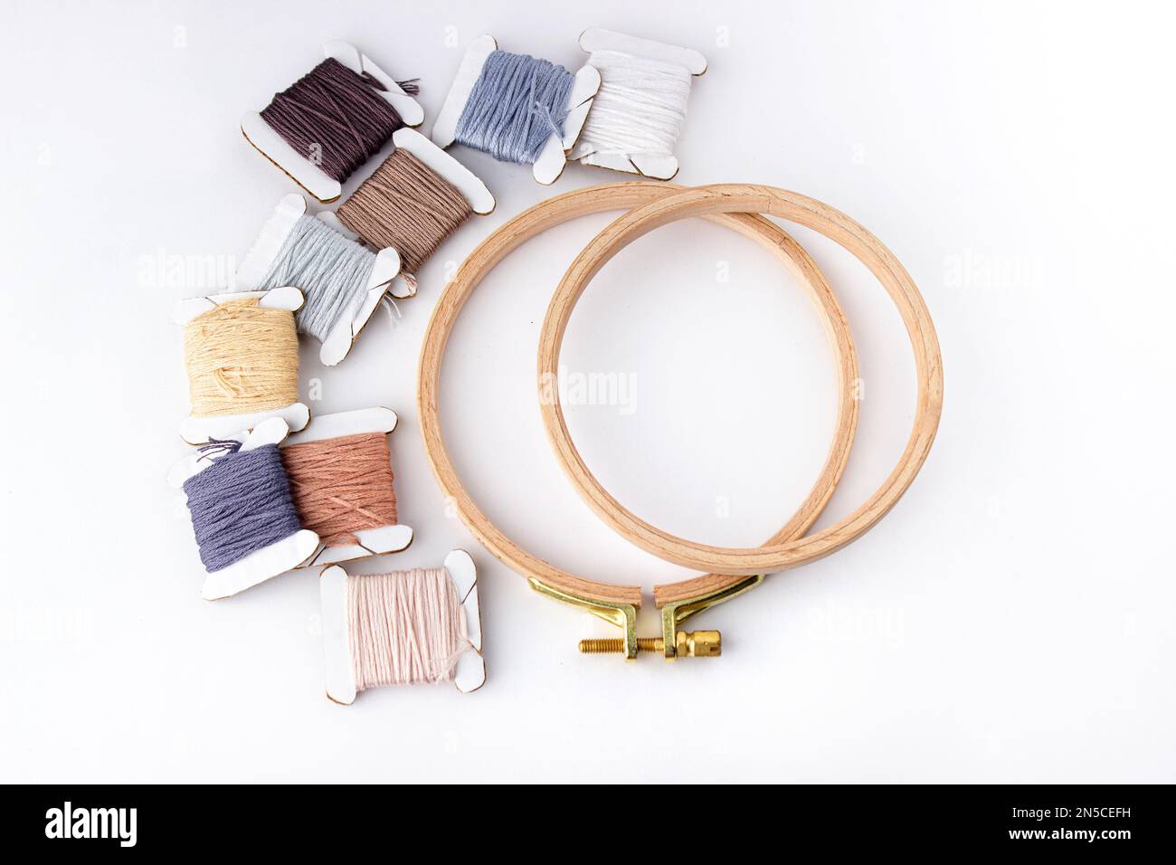 On a white background are cotton threads of different colors wound on ...