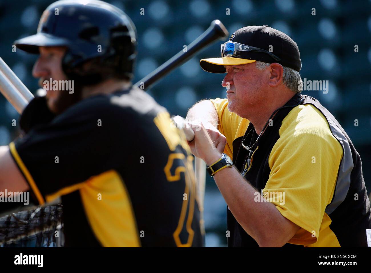 Pittsburgh Pirates manager Clint Hurdle, right, watches batting practice as newly acquired